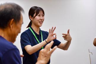 参加者に動きの説明をする学生